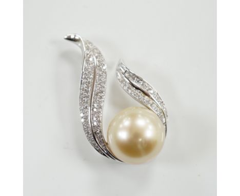 A modern 18ct white gold, single stone South Sea cultured pearl and diamond chip cluster set pendant, 32mm, gross weight 7.1 