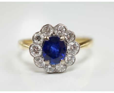 A modern 18ct gold, sapphire and diamond set circular cluster ring, size P/Q, gross weight 3.8 grams.***CONDITION REPORT***PL