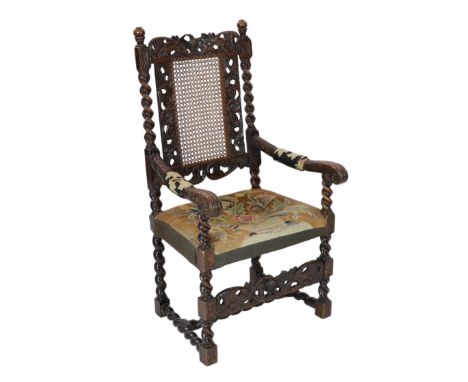 * * A Charles II carved walnut caned back elbow chair, with a contemporary needlework upholstered seat, c.1670, width 63cm, h