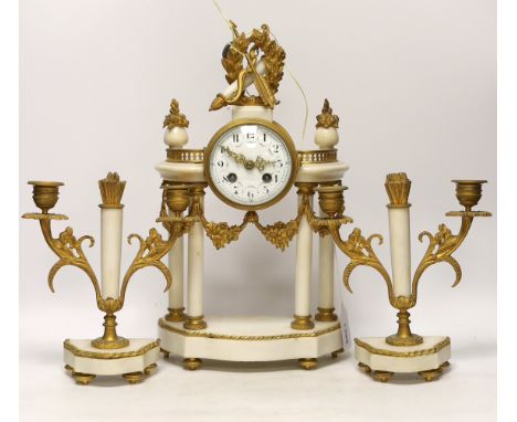 A French ormolu and white marble clock garniture, c.1900, striking on a gong, the dial decorated with swags, 40cm high***COND