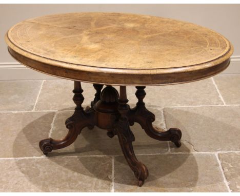 A Victorian burr walnut centre/loo table, the quarter veneered oval top inlaid with roundels and stringing, upon four ring tu