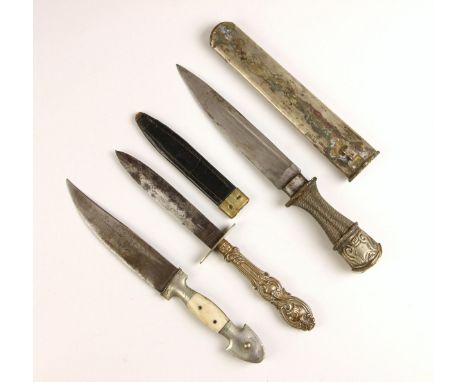 A Tibetan or Bhutanese Husa Khampa dagger and scabbard, probably 19th century, the wirework grip with repoussé silver coloure
