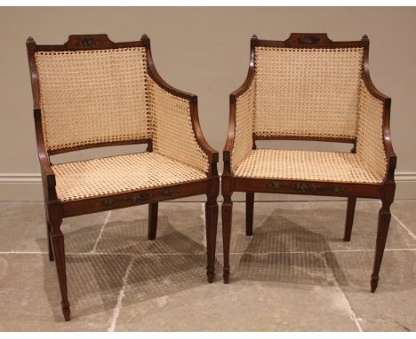 A pair of Sheraton revival satinwood and bergere chairs, late 19th/early 20th century, each with painted floral detail, outli