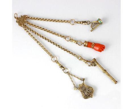 A 19th century gold coloured chatelaine, the florally engraved plaque suspending four trace link chains with coral Figa penda