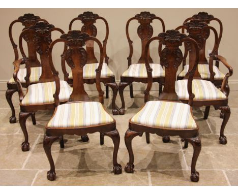 A set of eight George II style mahogany dining chairs, early to mid 20th century, each chair with a shell moulded crest exten