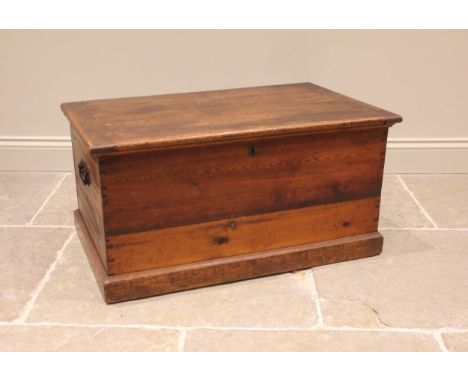 A Victorian pine blanket chest/trunk, applied with iron swing handles, upon a moulded plinth base, 43cm H x 87cm W x 54cm D