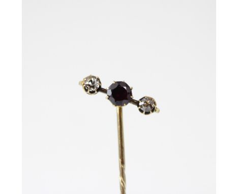 A 19th century diamond stick pin, the central pink stone with old cut diamond to each side, within yellow metal claw setting 