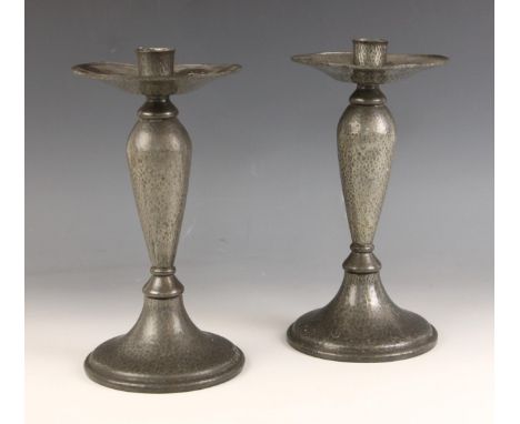 A pair of Tudric model 01223 hammered pewter Arts &amp; Crafts candlesticks, early 20th century, each of inverted teardrop fo