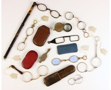 A Victorian folding lorgnette, late 19th century, the rectangular lenses retracting to a shaped silver coloured grip decorate