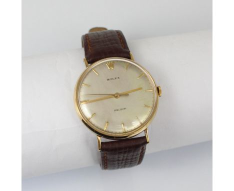 A mid 20th century 9ct gold Rolex Precision wristwatch, the silver coloured dial with baton markers, set to a plain polished 