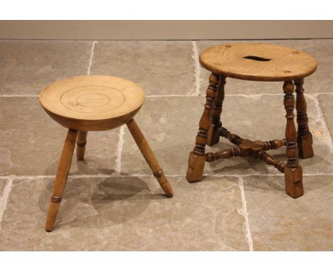 A 19th century sycamore milking stool, the dished circular seat upon three splayed and ring turned beech wood legs, 37cm H x 