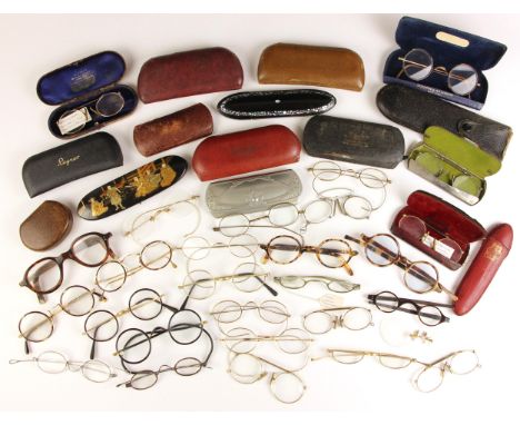 A large collection of vintage spectacles, late 19th century and later, various sizes, to include some examples of folding eye