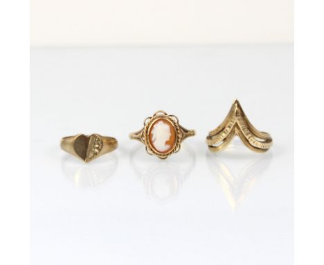 A group of three yellow metal rings, including a 9ct dress ring, designed as a textured openwork chevron, stamped to shank, r