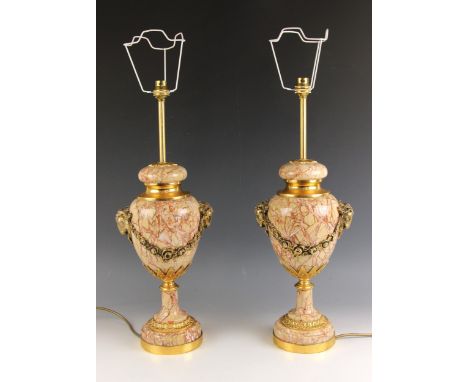 A pair of coral coloured variegated marble and ormolu mounted table lamps, early 20th century, each of ovoid vase form applie