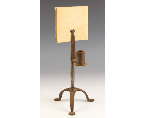 An 18th century wrought iron rush nip or light, supported by three legs with pad feet, with single candle holder, 21cm highCo