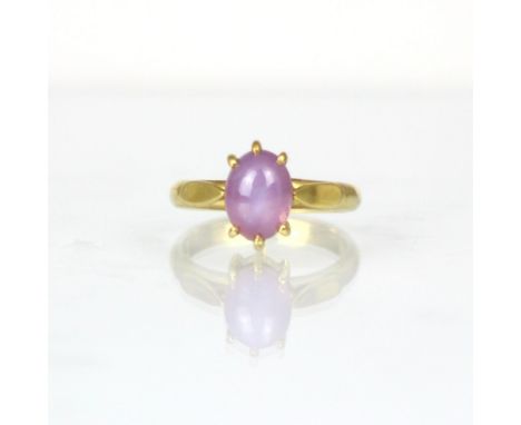 A bespoke untested star ruby ring, the oval cabochon displaying six ray star, within yellow metal claw setting edge leading t