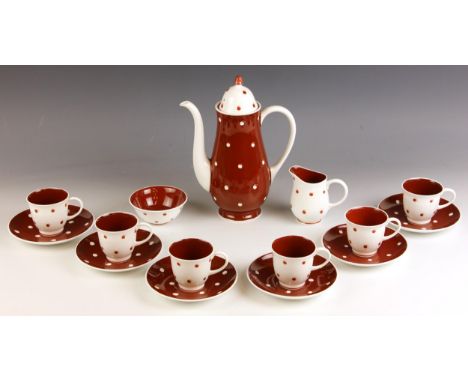 A Susie Cooper coffee service, mid 20th century, comprising: a coffee pot and cover, 24cm high, six coffee cups and saucers, 