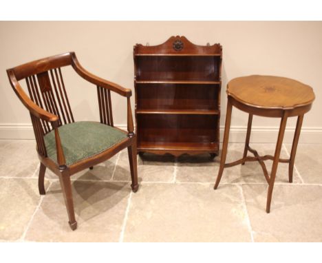 An Edwardian mahogany and inlaid library chair, the down swept arms over a padded serpentine seat, tapering front legs of squ