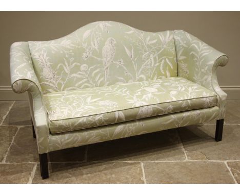 A George III style sofa, mid 20th century, in parrot and foliage print fabric, the camel back extending to scrolled arms encl