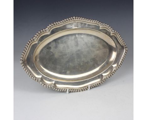 A George II silver serving dish, indistinct makers mark, London 1759, the gadrooned rim above shaped well with crest (rubbed)