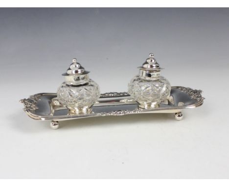A Victorian silver desk tidy, Josiah Williams &amp; Co, London 1895, the shaped rectangular tray with floral detail, encompas