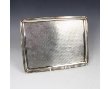 A George V silver dressing table tray, indistinct makers mark, Birmingham 1924, of rectangular form with all over engine turn