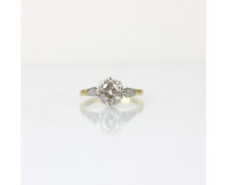 An Edwardian style diamond solitaire, the central round cut diamond within stylised white metal illusion setting edge, leadin