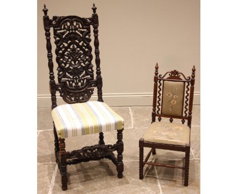 A Carolean revival carved oak hall chair, 19th century, the carved openwork back rest over a re-upholstered seat, upon bobbin