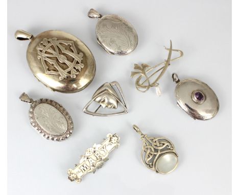 A selection of white metal lockets and brooches, including a white metal Art Deco style brooch, of asymmetrical form with pro