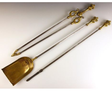 A George III steel and brass fireside companion set, comprising; a poker, 70.5cm long, a shovel, 71.5cm long, and tongs, 67.5