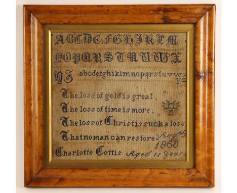 A Victorian needlework sampler dated 1860, worked by Charlotte Cottis, aged eleven years, depicting a gothic alphabet above a