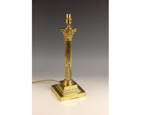 A lacquered brass table lamp base, 20th century, modelled as a Corinthian capital raised on a fluted and part reeded column s