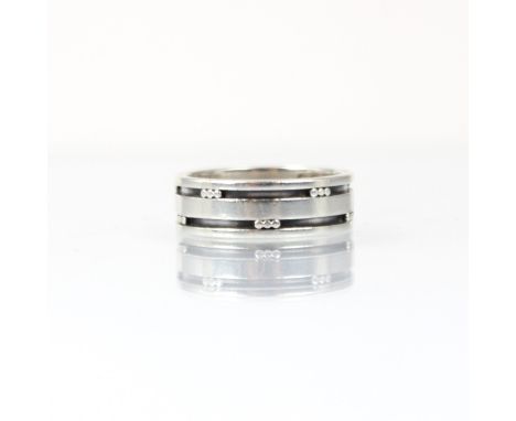 A Georg Jensen silver ring, the double grooved band ring with triple spherical detail, stamped 'Georg Jensen Denmark 60 D' ri