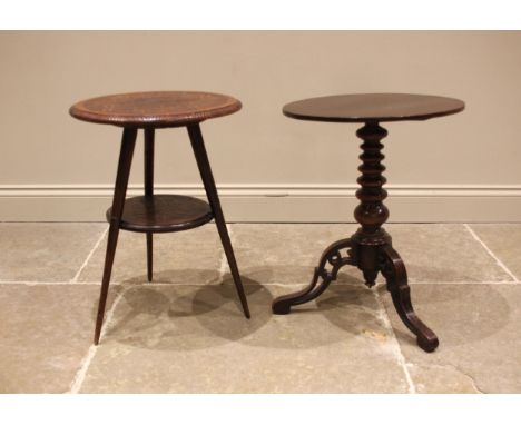 A circular carved oak occasional table, early 20th century, the top carved with bamboo foliate detail over a conforming gradu