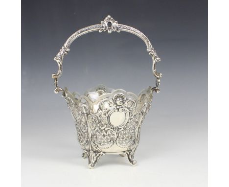 An early 20th century Russian silver sugar basket, WH, Kostroma, the cast shaped swing handle above openwork basket, with mon