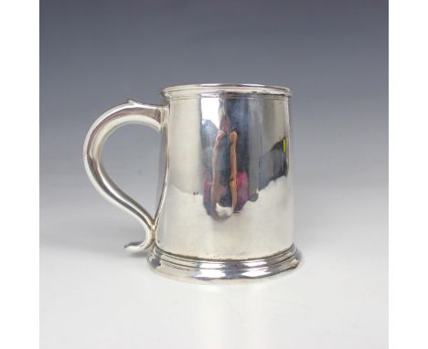 A George III silver mug, indistinct makers mark, Newcastle 1769, of plain polished tapered cylindrical form, upon spreading c