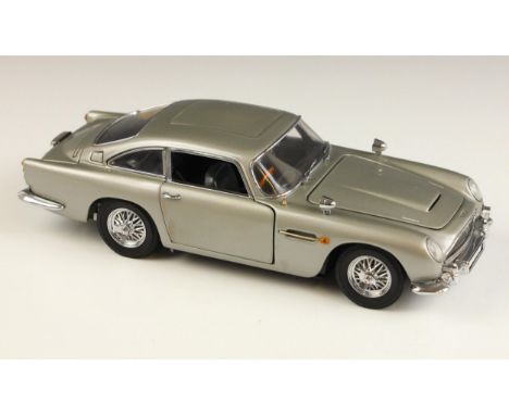 A Danbury Mint 1:24 scale James Bond 007 Aston Martin DB5, 19cm long, in original packaging, with certificate, with three Fra