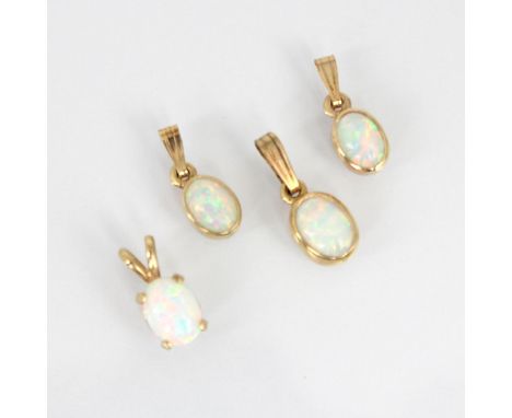 A group of four yellow metal mounted opal pendants, all of oval opal cabochon form within rubover mounts, largest 1.8cm – sma