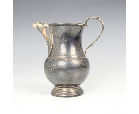 A silver milk jug, Cooper Brothers &amp; Sons Ltd, Sheffield 1970, the shaped handle above bulbous body, with gilt interior, 