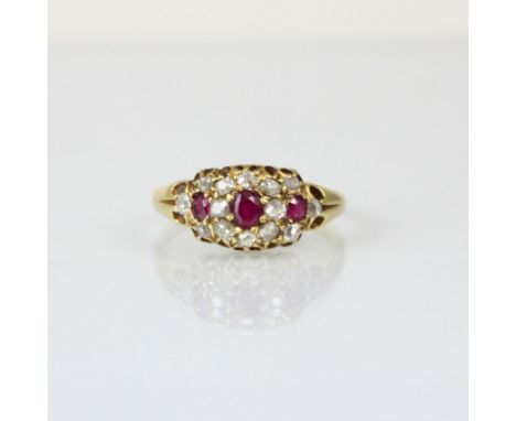 A 19th century diamond and untested ruby ring, the central cushion cut stone with smaller cushion cut stone to each side with