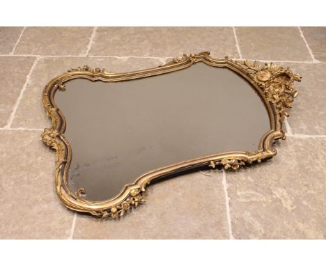 A French Louis XVI style gilt wood and gesso wall mirror, late 19th/early 20th century, the moulded musical instrument and wr