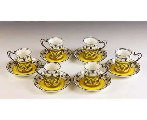 A set of six early 20th century silver mounted coffee cans and saucers, James Deakin & Sons, Sheffield 1921, the openwork mou