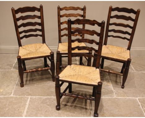 A matched set of four ash Lancashire ladder back kitchen chairs, early 19th century,each with a shaped rung back over an enve
