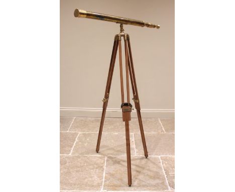 A reproduction lacquered brass telescope by Nauticalia, serial number 012017, 101cm long, mounted on a conforming wooden trip