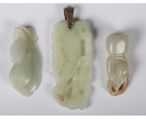 A group of three Chinese jade pendants, late Qing dynasty, comprising one of mottled celadon tone, carved and pierced in the 
