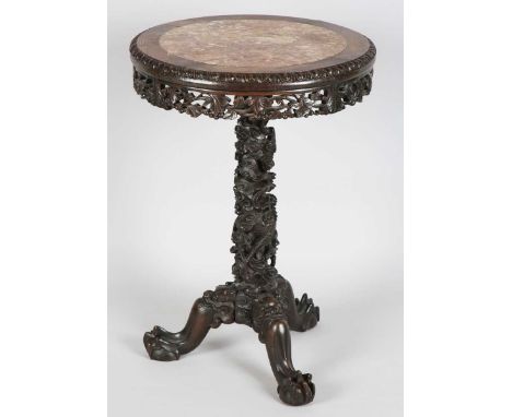 A Chinese hardwood wine table, late 19th century, the circular top inset with a rouge marble panel within a carved foliate bo