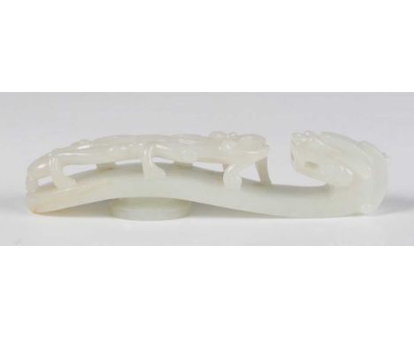 A Chinese white jade belt hook, probably late Qing dynasty, of typical serpentine form, carved and pierced with a chilong con