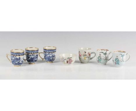 A group of three Chinese blue and white export porcelain coffee cups, Qianlong period, painted with pavilions in a coastal la