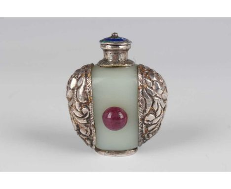 A Tibetan white metal mounted pale celadon jade snuff bottle, probably early 20th century, of flattened circular form, applie