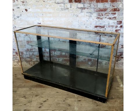 An early 20th century shop display counter, adjustable metal shelf interior 154 wide x 91high x 56.5cm deep c.1920 